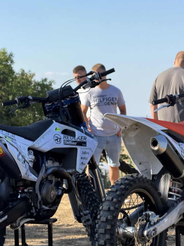 Motocross-Motorrad mit AMC-Geseke- und Redeker-Tiefbau-Aufklebern beim Sommerfest